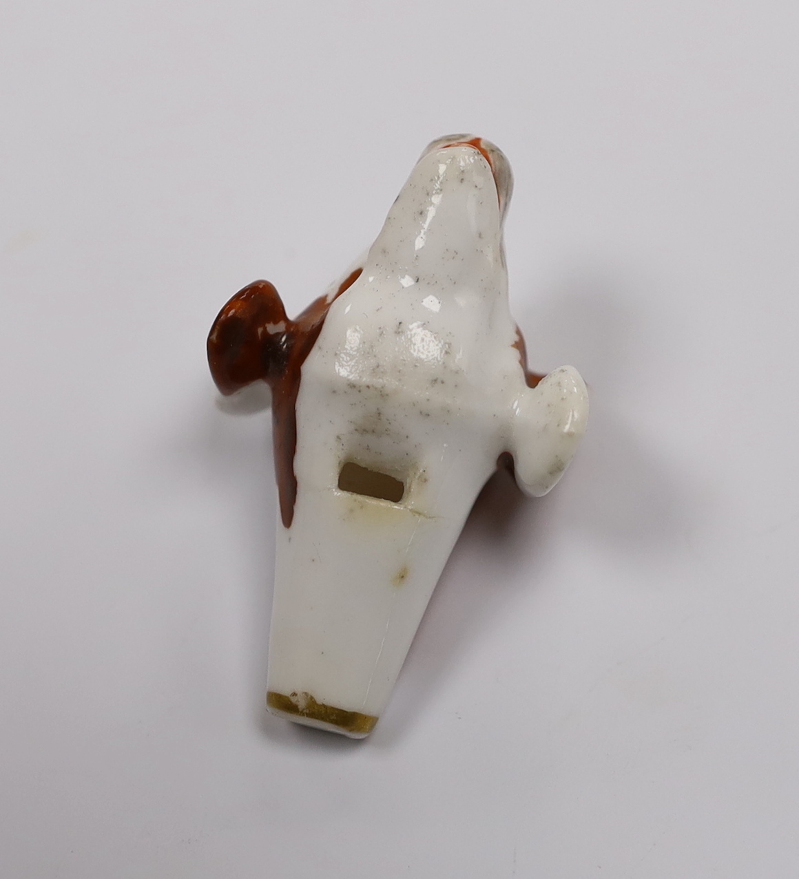 An early 19th century Staffordshire porcelain dog’s head whistle, 5cm